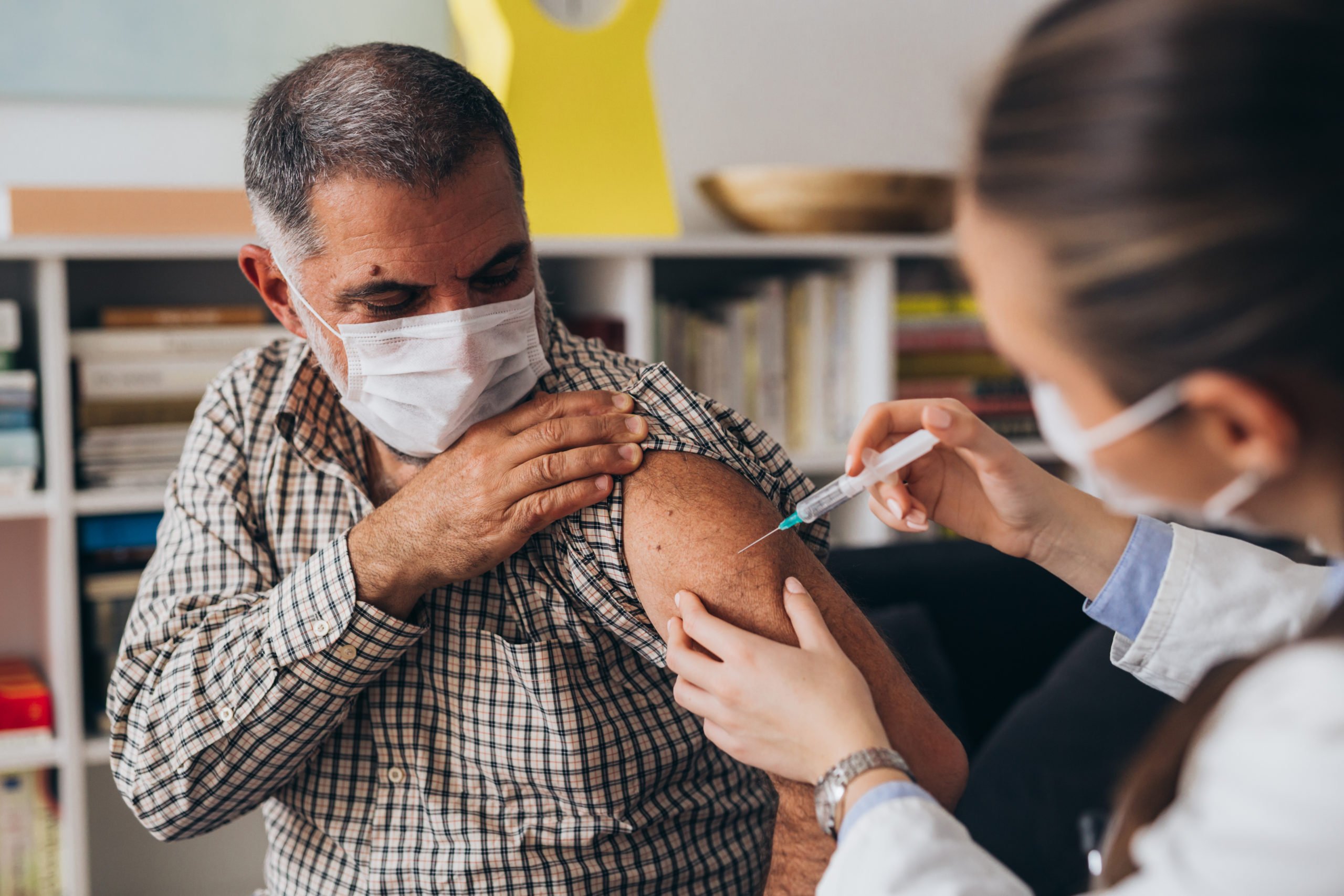 A man receives a COVID-19 vaccine